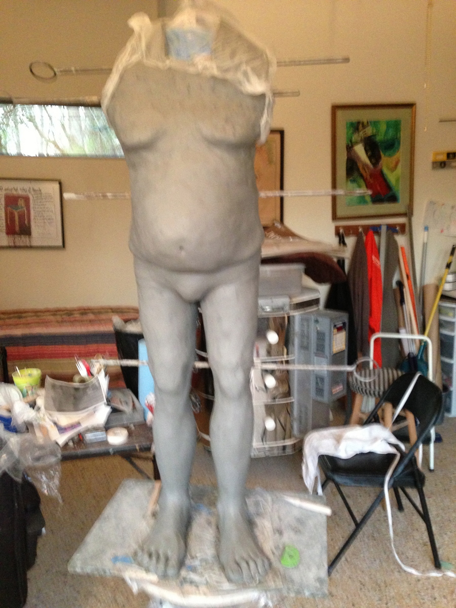 Here I added Luigi's upper torso and breasts. The horizontal rods help keep the heavy clay from sliding down.